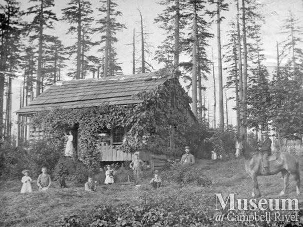 The Yeatmans in front of their log cabin at Sunnyside Farm, Quadra Island