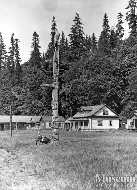 View of totem pole and houses at Cape Mudge Village, Quadra Island