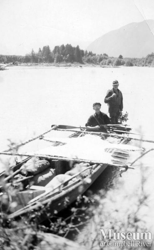 Two hunters with grizzly bear hide at Knight Inlet	